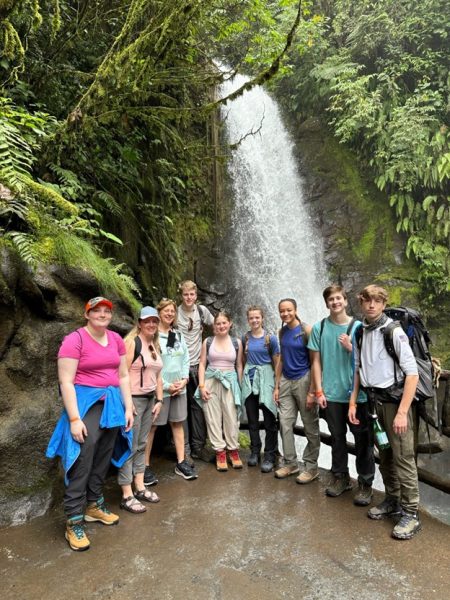 Students standing by waterfall in Costa Rica